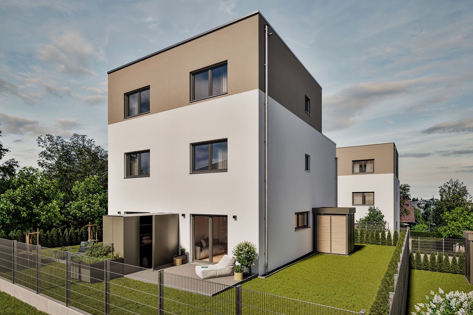 Rückansicht eines modernen FingerHaus Wohnhauses im Baugebiet Bad Nauheim-PUR mit Terrasse, Garten und großen Fensterfronten.